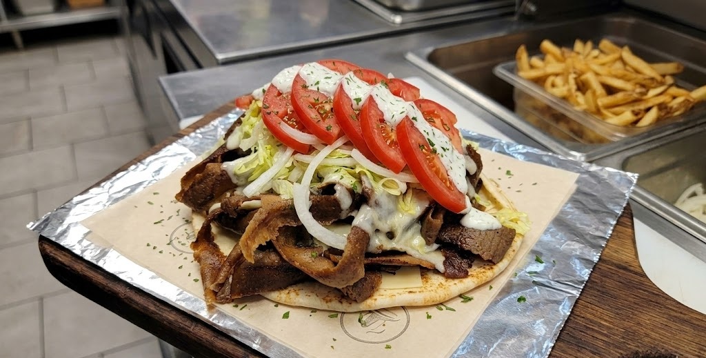 Cheese donair at Donair and Shawarma House Sherwood Park - donair meat with melted cheese, lettuce, tomato and onion on pita